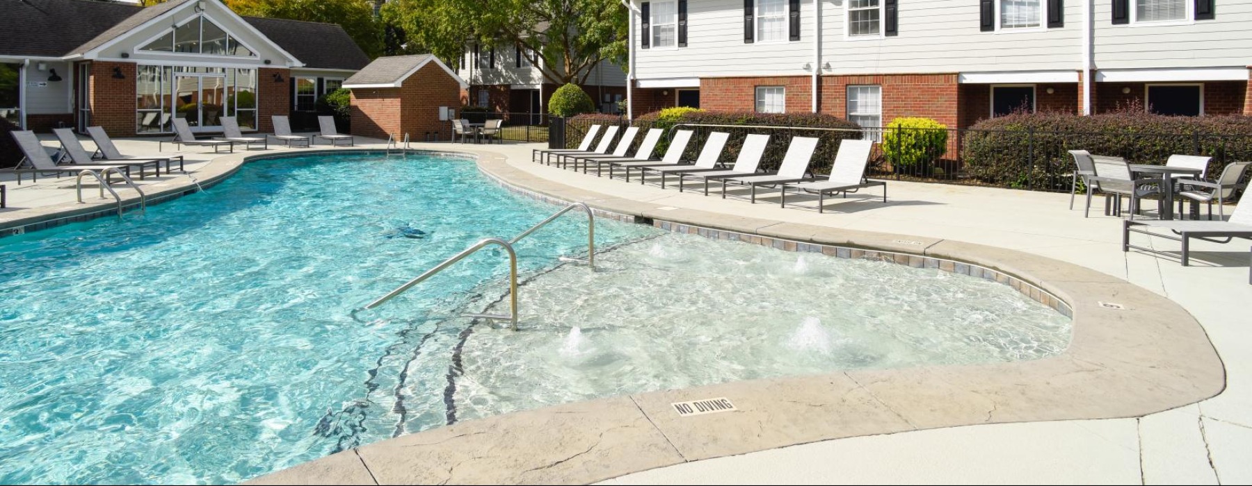 Resort-style swimming pool with lounge seating