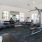 a room with exercise equipment and a rug
