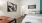 bedroom with full bed, desk for studying, and black and white geometric paintings on the wall