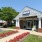 exterior photo of the front leasing office with pink flowered landscaping