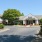 exterior photo of the front leasing office with pink flowered landscaping