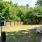 enclosed dog park outside with white picnic chairs 
