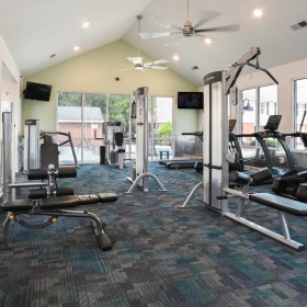 Get your workout on a room with exercise equipment and chairs