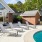 a swimming pool with chairs around it