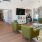 a club room with green chairs