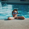 girl with her arms crossed hanging in the pool