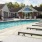 a swimming pool with chairs around it